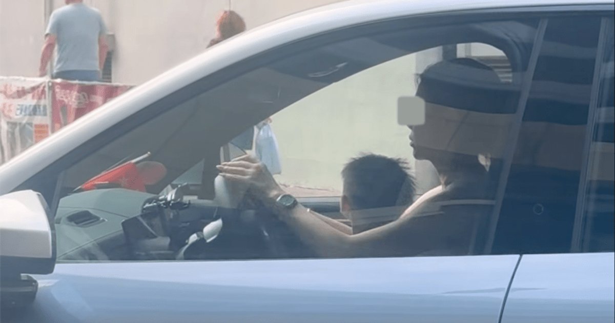 Woman charged after child seen on lap while driving